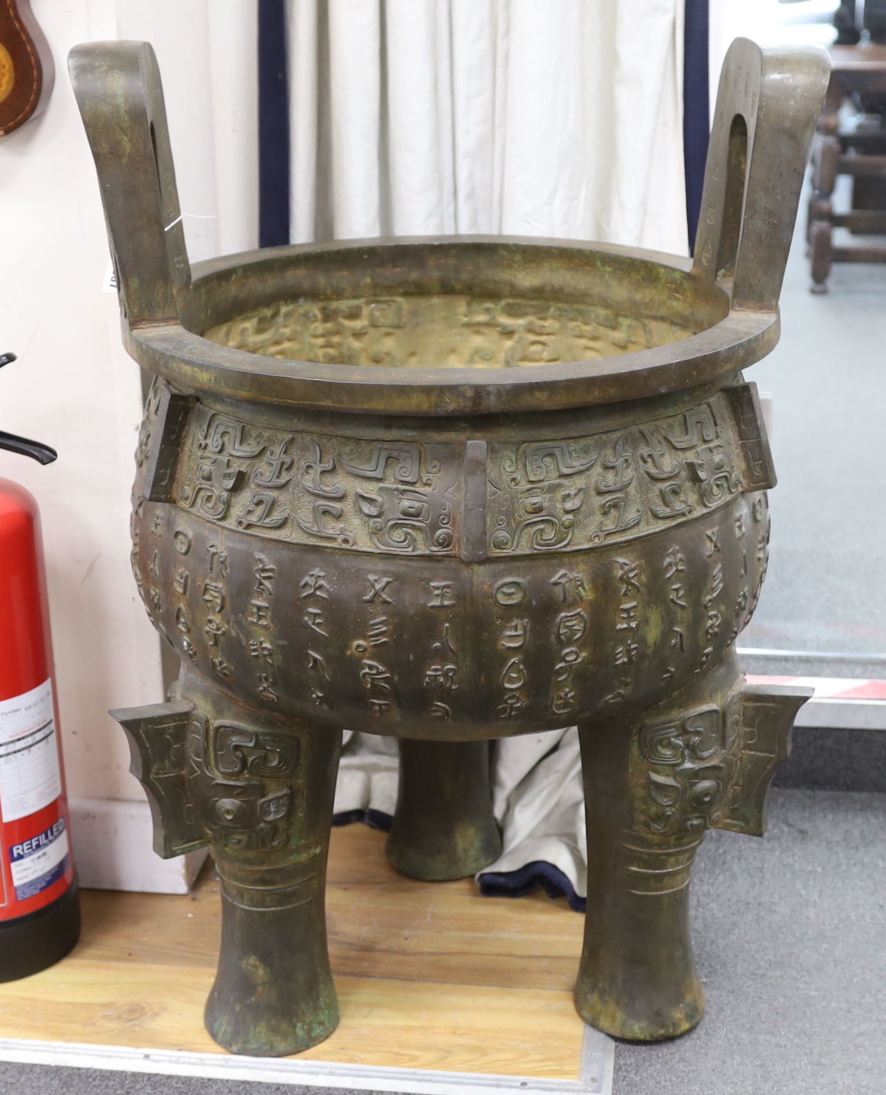 A massive Chinese bronze tripod vessel, ding, 85cm tall